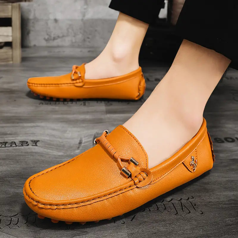 Les chaussures à enfiler habillées en cuir se portent sans effort avec des chaussures décontractées en cuir orange, avec une bride tressée et un détail de boucle métallique.
