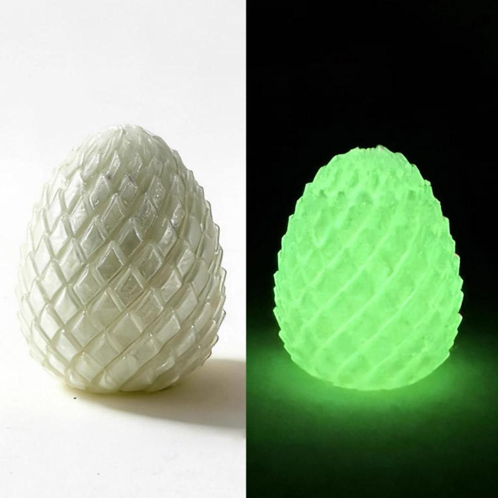 A textured egg-shaped fidget toy with a grid-like pattern glowing bright green in the dark, representing an articulated dragon egg.