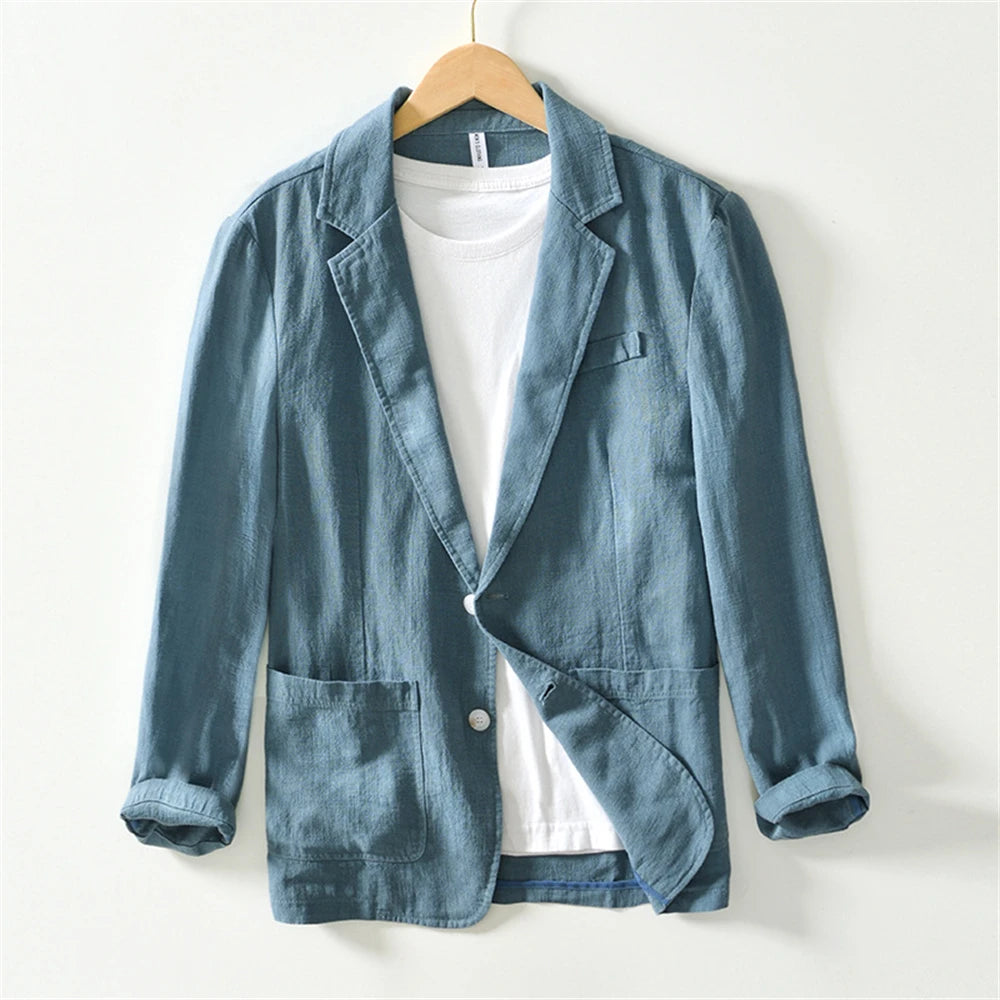 Men’s lightweight blue linen casual blazer jacket with a single button closure and rolled-up sleeves.