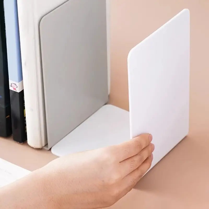 White plastic l shaped minimalist bookend with a smooth design for desktop use.