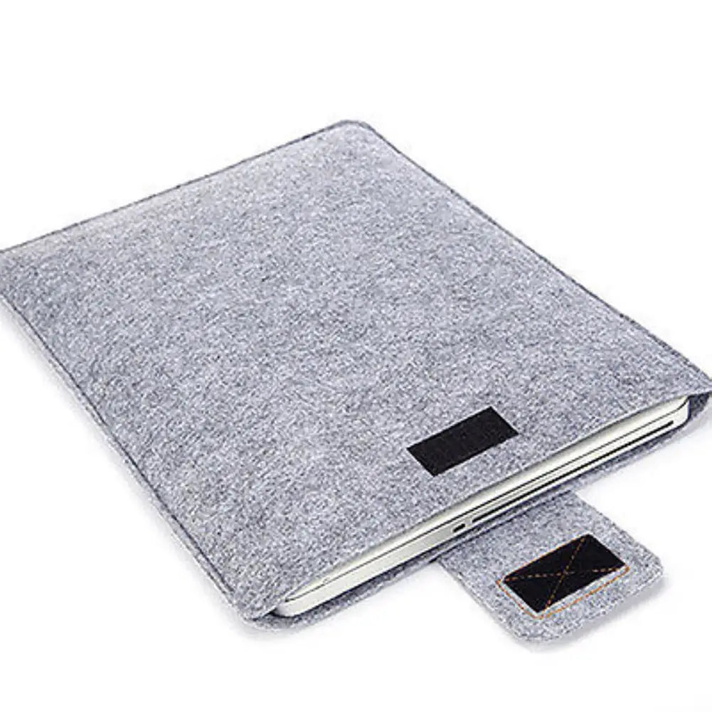 gray felt laptop bag sleeve for macbook air with black fabric patches and stitched detailing designed as a protective tablet bag