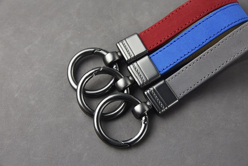 Leather keychains set with multicolor red blue and gray suede straps and metal clasp attachments for secure key organization.