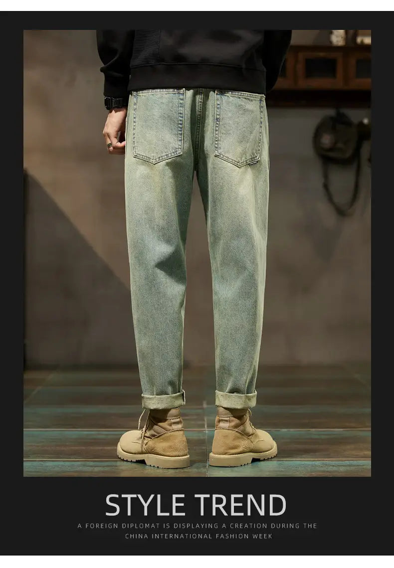 Men loose denim harem jeans in light-wash denim with a relaxed fit and cuffed hems.