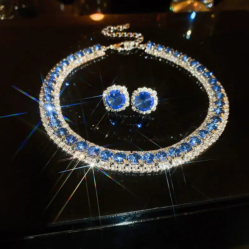 A dazzling blue sapphire and diamond crystal necklace and earring set with sparkling silver-toned metal designed as pink ab wedding jewelry.