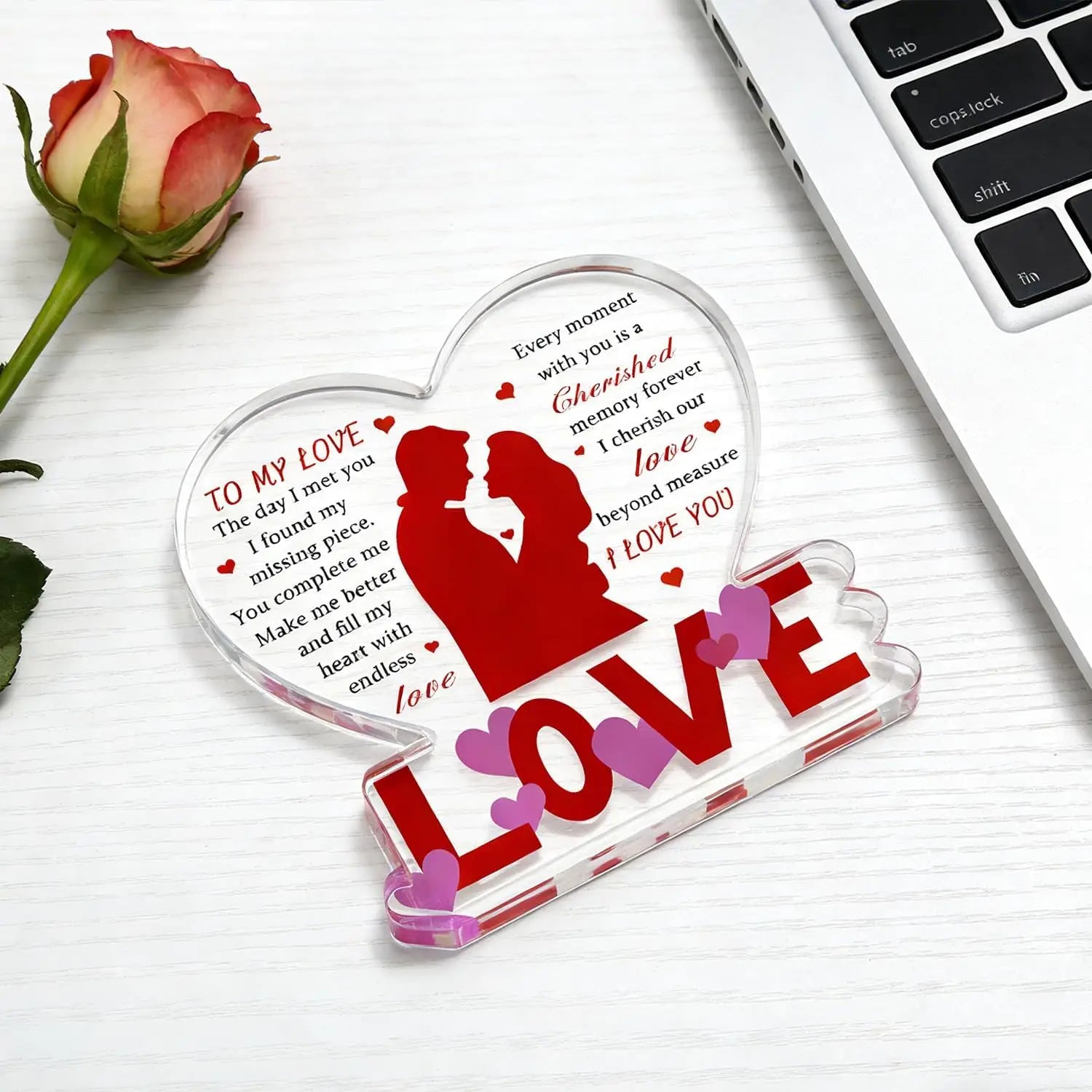 Clear acrylic heart keepsake plaque with red and pink laser etched romantic message silhouette of kissing couple and bold love lettering for Valentine gift.