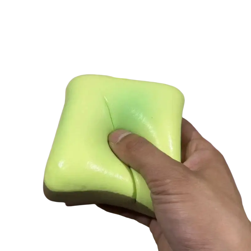 A lime green square slow rising squishy toy with a soft glossy surface for stress relief and fidgeting