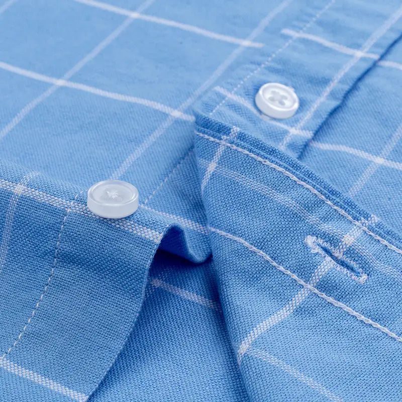 Men’s cotton Oxford slim fit plaid shirt in light blue and white checkered pattern with clear plastic buttons.