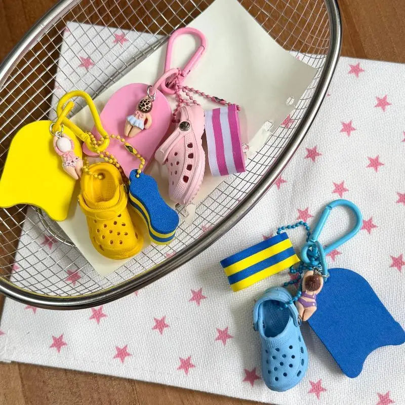 mini clog keychain beach bag charm featuring pink and yellow croc-themed keychains with miniature shoe charms and beach accessories.
