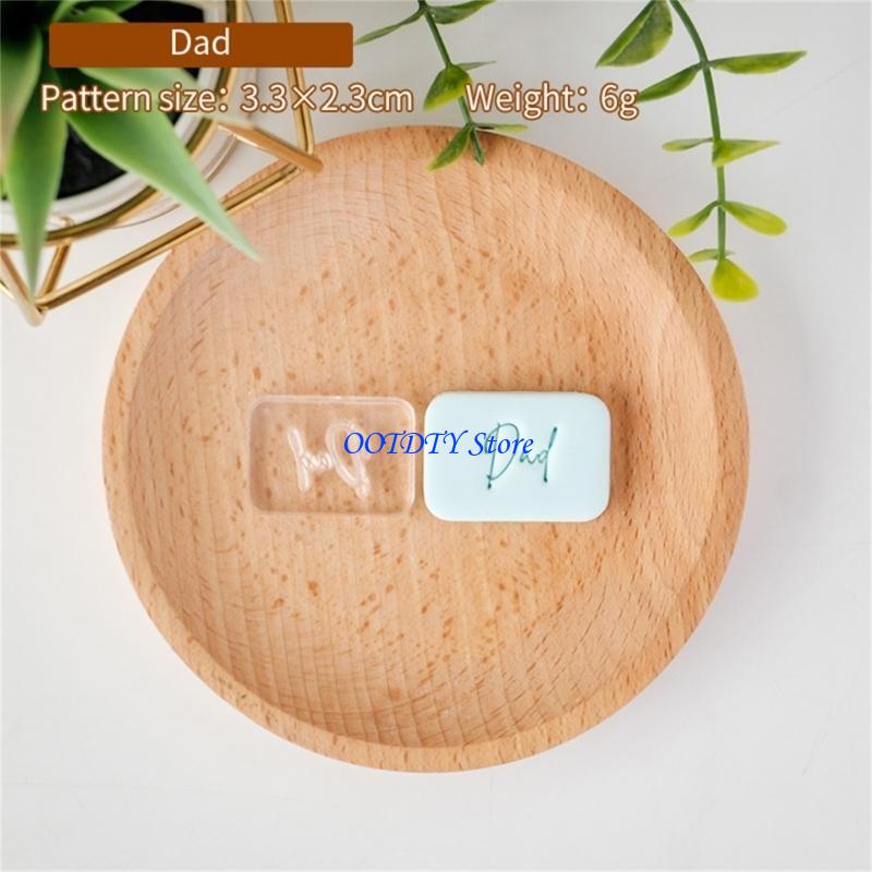 clear and white rectangular resin father’s day cookie cutter and fondant stamp keepsakes engraved with the word dad in cursive script