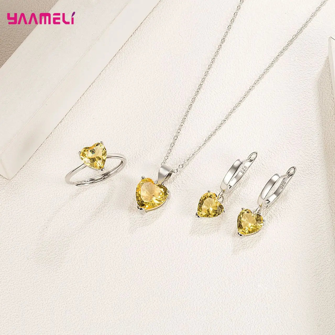Sterling silver heart jewelry set featuring yellow zircon heart-shaped gemstones in a silver-toned metal setting.