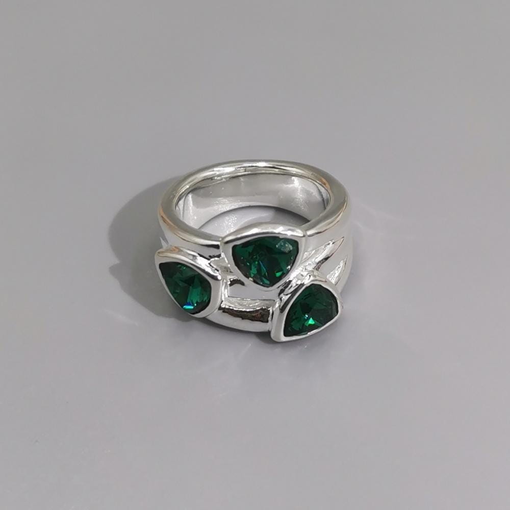 Silver geometric open ring featuring three vibrant green triangular crystals set in a modern branch-like design in silver and gold metal jewelry.