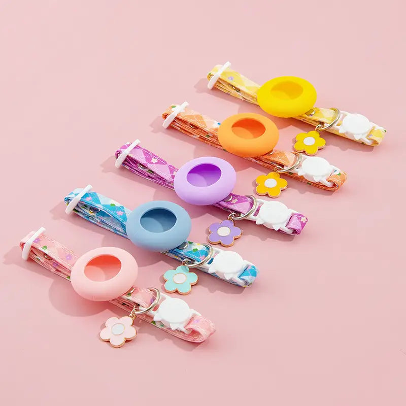 pastel-colored silicone airtag cat collars with floral-patterned fabric straps and matching flower-shaped charms featuring an airtag protective case for outdoor park dog and park dog cat use
