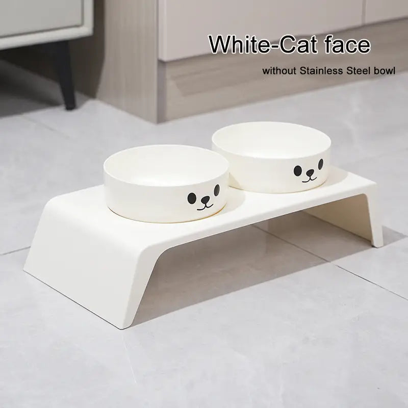 Elevated dog feeder raised stand in white with stainless steel bowls featuring black cartoon cat faces for pet feeding.