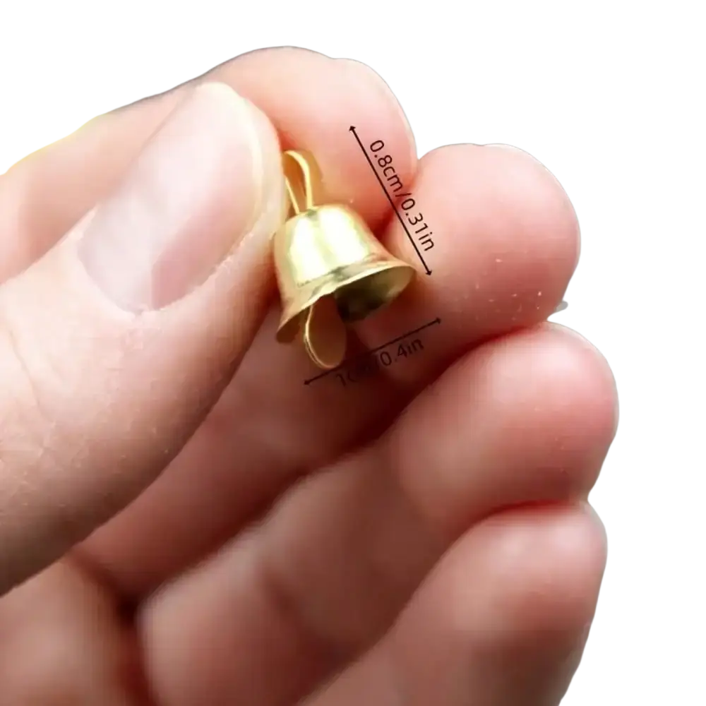A tiny gold-colored metal bell pendant 0.8 cm high and 0.4 inch wide for DIY and festival decorations