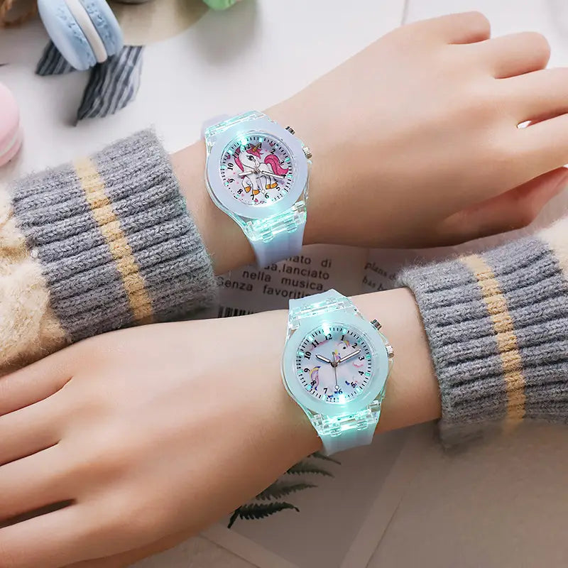 Light blue translucent plastic kids unicorn led light up silicone digital watches with glowing faces and cartoon designs.