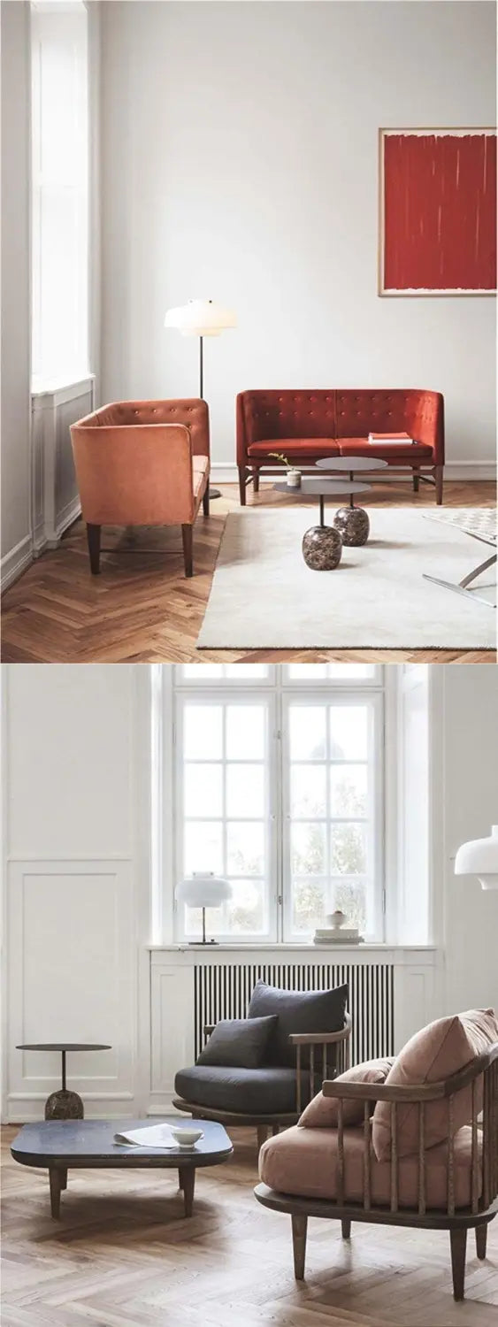 The image features a minimalist marble metal round side table next to a pair of modern armchairs with dark wooden frames and plush upholstered seats in muted tones.