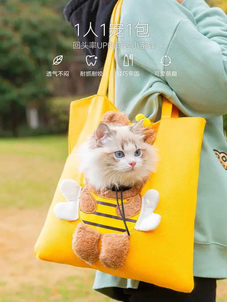 Bright yellow canvas pet carrier bag designed with plush brown wings and striped body in a bee theme for small dog and cat use featuring a mouth length suitable for comfortable carrying.