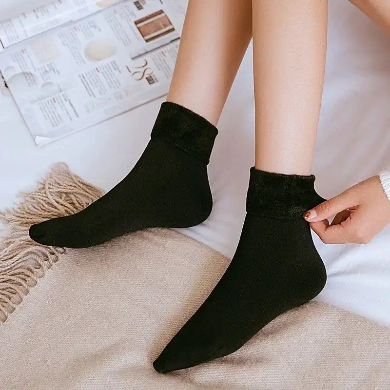 black ankle-length winter thermal socks with plush fuzzy lining at the top made of cashmere wool for enhanced warmth and comfort