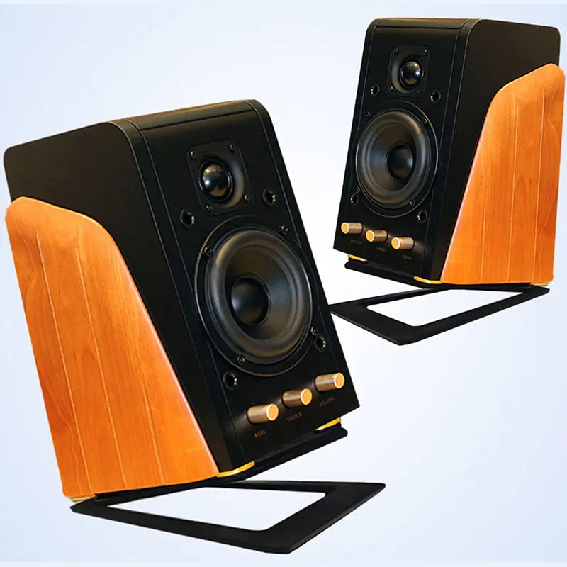 aluminum desktop speaker stands with 16 degree tilt paired with black and walnut-finished bookshelf speakers featuring gold-tone control knobs