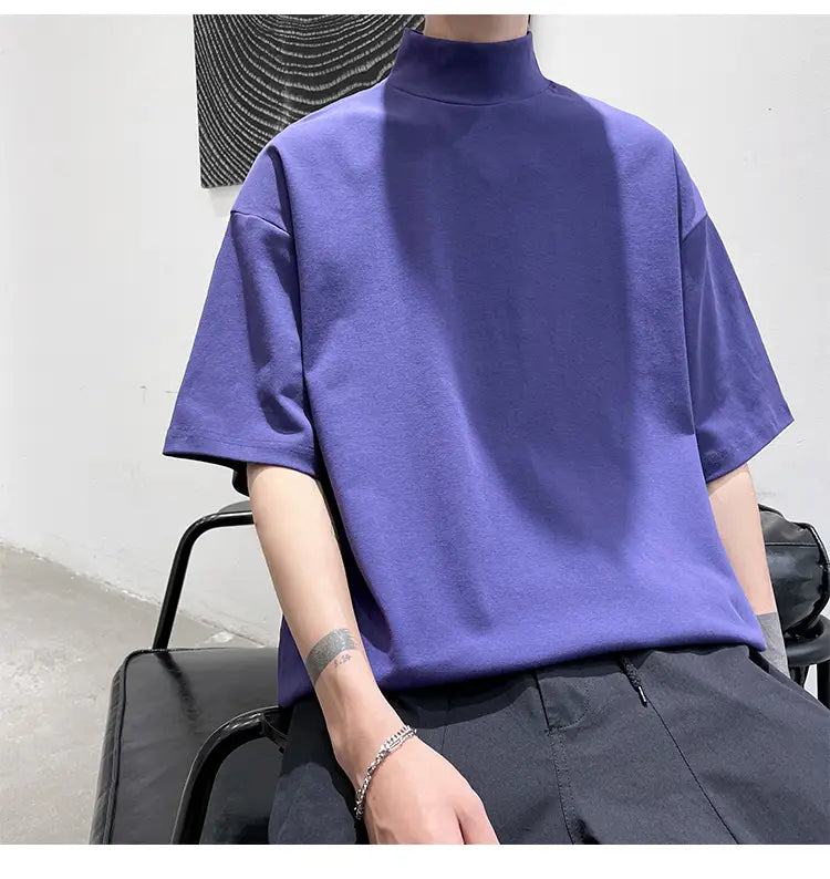 Men oversized turtleneck t-shirt in solid purple made of soft cotton fabric featuring short sleeves for casual streetwear.