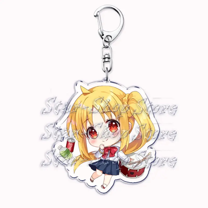 Clear acrylic keychain featuring a chibi-style anime girl with blonde hair and red eyes in a school uniform holding drumsticks beside a small drum from Bocchi the Rock.