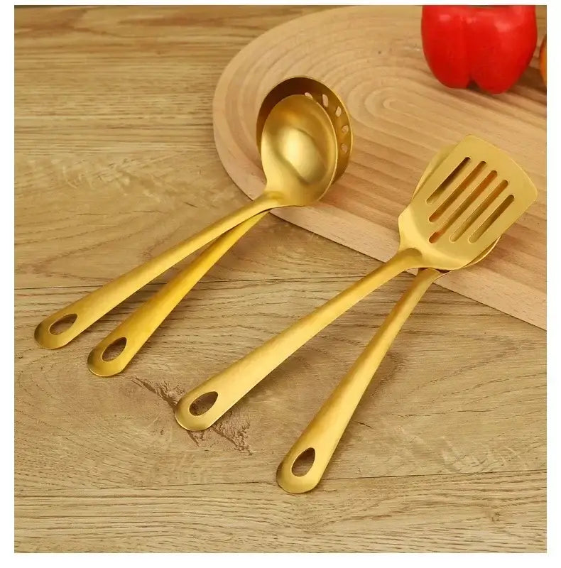 gold kitchen utensil set featuring gold-colored stainless steel slotted spoon and spatula with sleek modern handles for cooking.