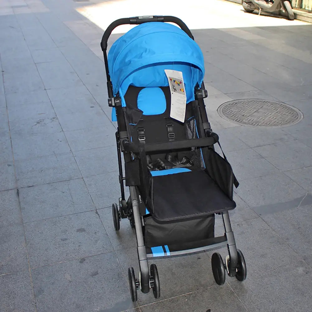blue and black foldable stroller with canopy seat storage basket and four wheels featuring a universal stroller extension footrest infant footboard visible from the back side