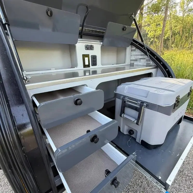 Gray durable plastic and metal storage unit with black knobs on a custom teardrop travel trailer fully equipped camper.