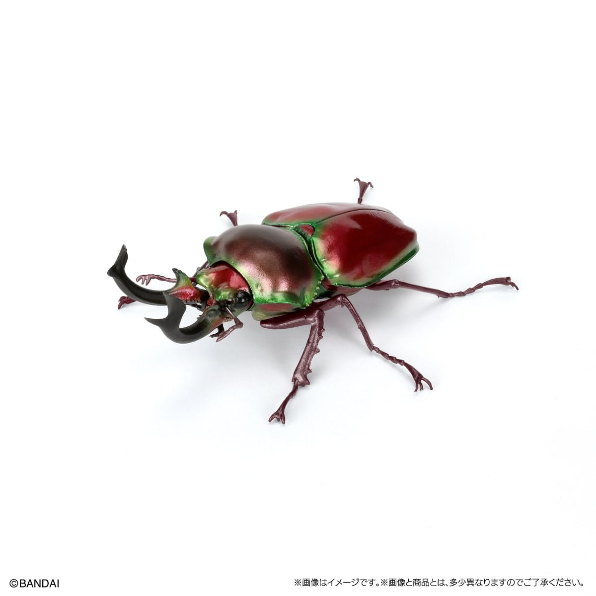 黒い角のような角(つの)を備えた、光沢のある金属質の赤と緑のバンダイのノコギリクワガタ完成品モデル玩具です。