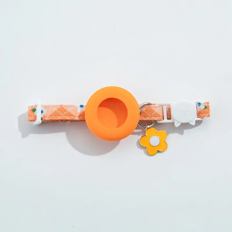 orange patterned airtag cat collar with circular silicone ring and yellow flower charm featuring an airtag protective case designed for park dog cat use