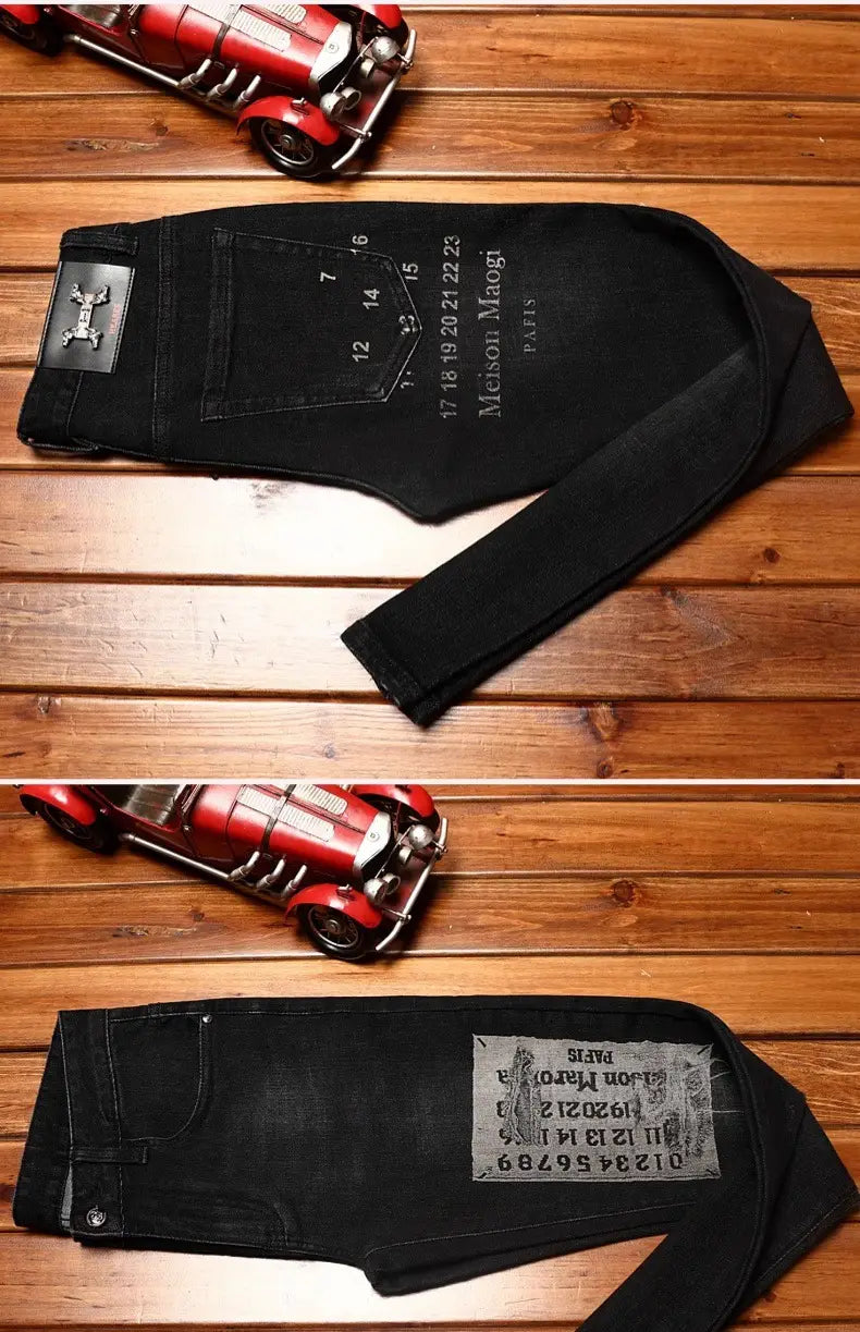 The back side of mens slim fit printed black denim jeans features a silver-toned metal patch on the back pocket and embroidered maison margiela paris text.