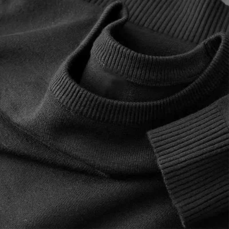 Schwarzer Rippstrick-Rollkragenpullover mit weich strukturierter Stoffoberfläche im klassischen Herren-Strickpullover-Stil mit Rundhalsausschnitt.