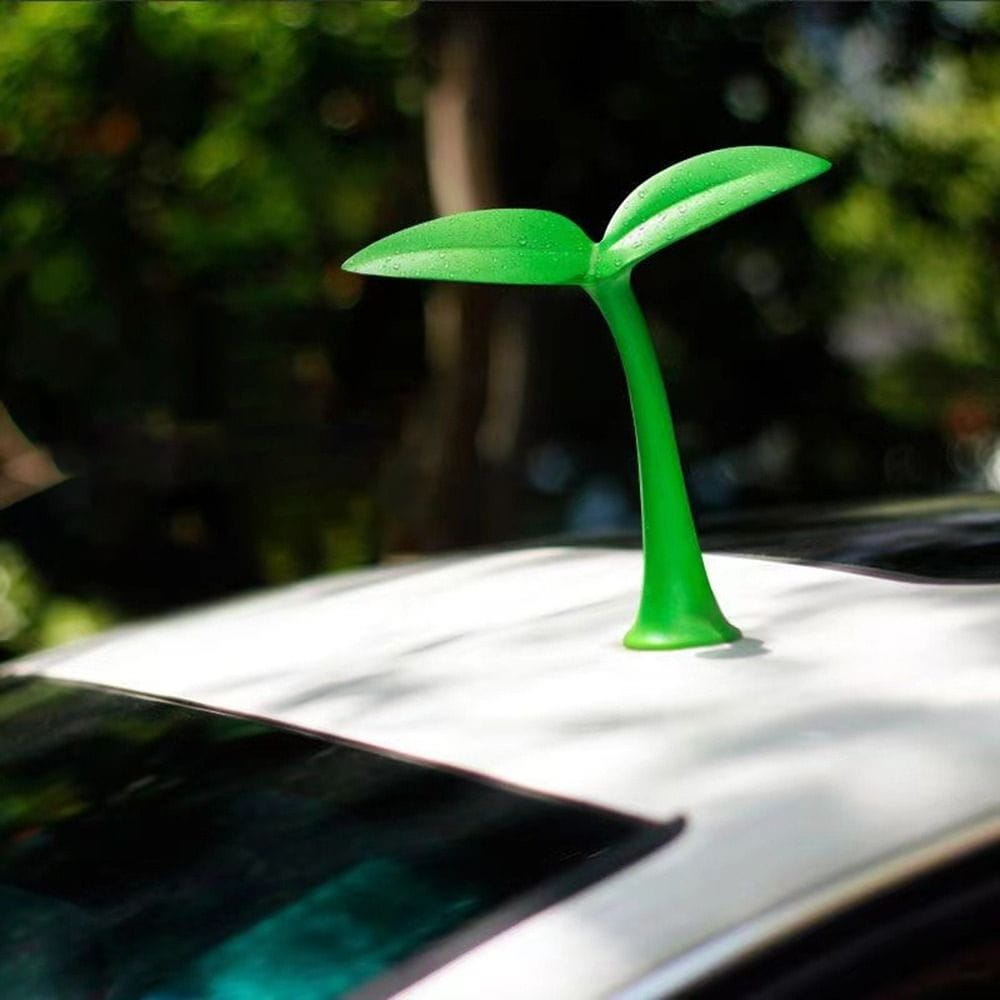 Décoration d’antenne de toit de voiture en forme de jeune arbre en 3D, en plastique vert vif, avec une finition lisse et brillante et des feuilles stylisées.