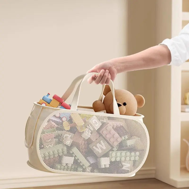 Beige mesh toy storage basket with large capacity white handles filled with toys and a stuffed bear for organized storage.