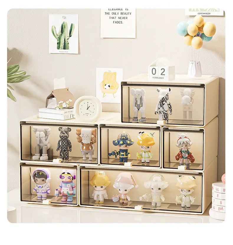 beige transparent drawer storage unit made of plastic with multiple compartments used as a desktop organizer and collectible display case holding colorful figurines.