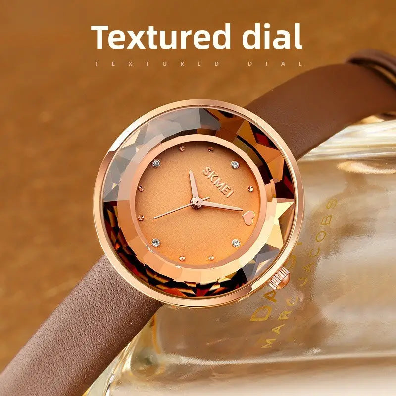 Rose gold-toned skmei floral quartz watch with a textured dial diamond-like hour markers a heart-shaped accent near 3 o’clock and a leather strap presented in a gift box