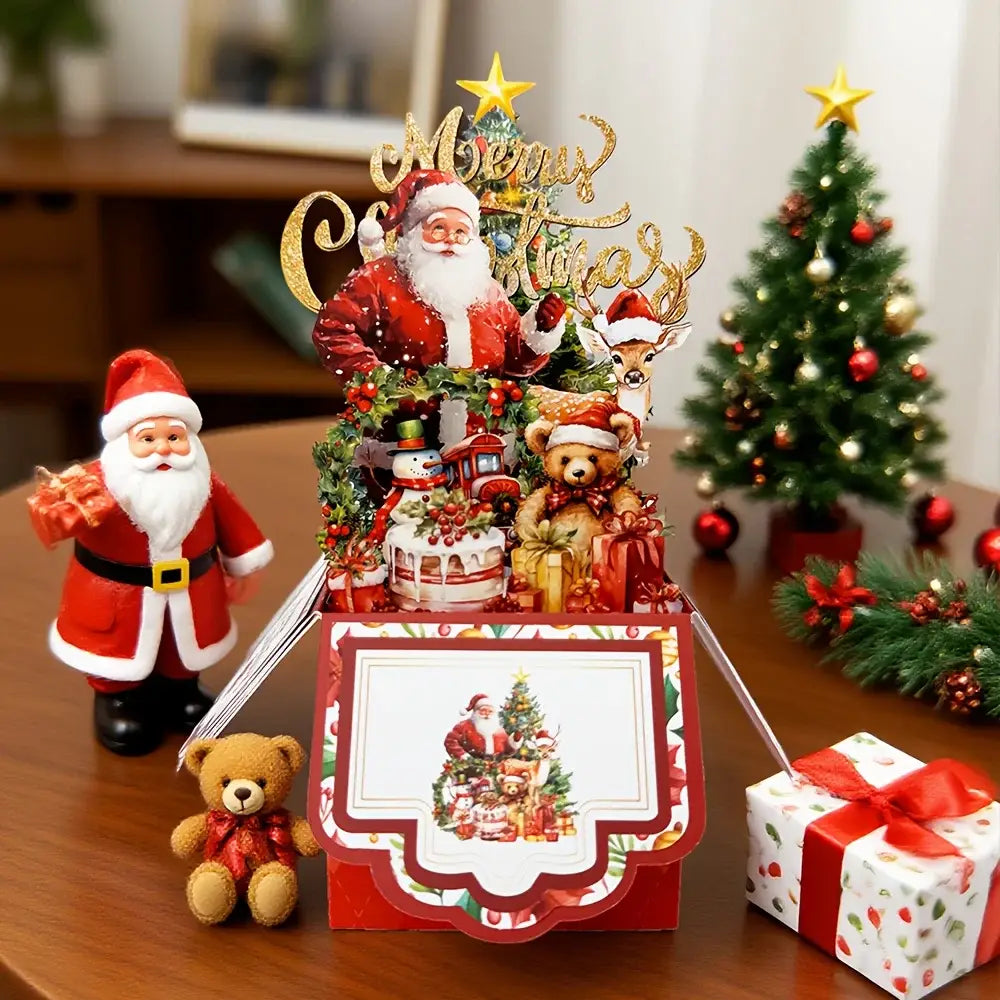 赤を基調としたクリスマスをテーマにした3Dのサンタクロースが飛び出す（ポップアップ）グリーティングカードで、サンタ、トナカイ、雪だるま、テディベアの置物が、緑の装飾やオーナメントに囲まれた華やかな場面を描いています。