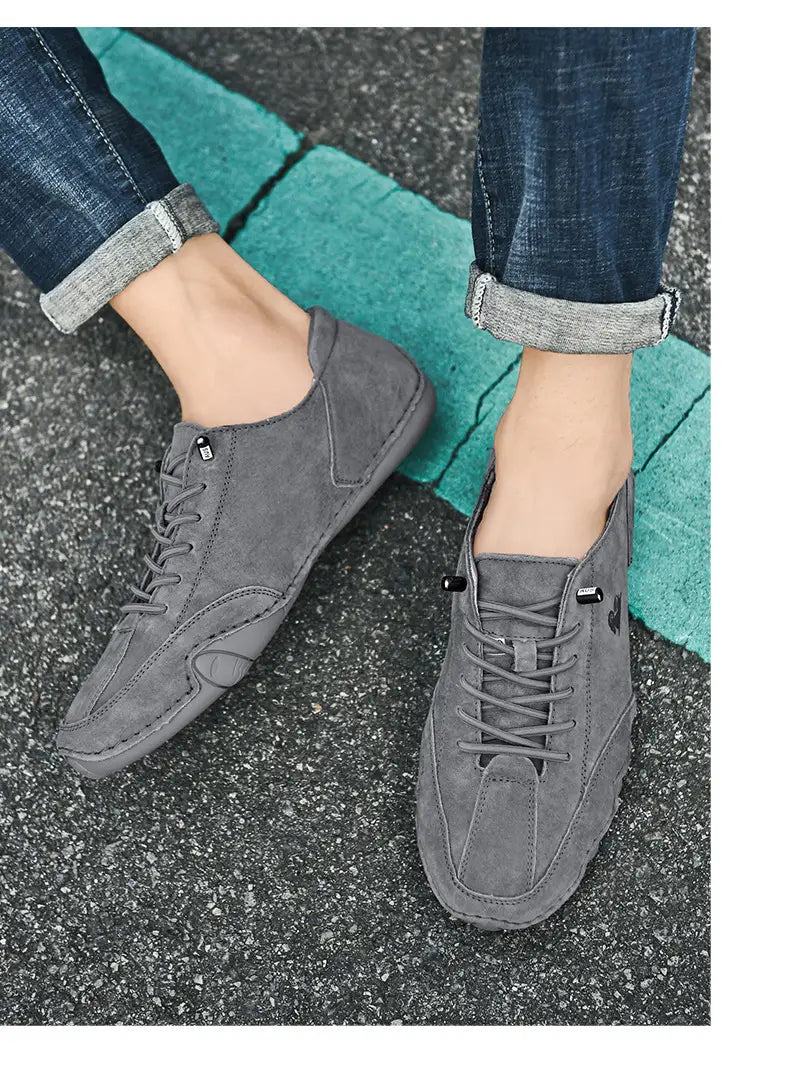 Men high top leather casual sneakers in gray suede with black laces and subtle stitching details.