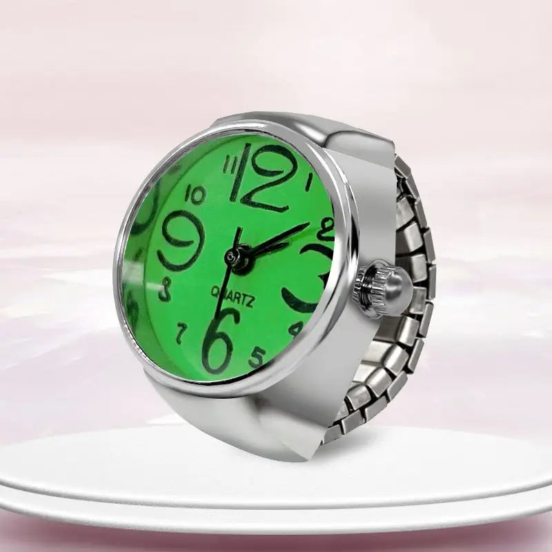 A sleek silver-toned ring watch quartz finger couple jewelry featuring a vibrant green face with bold black numerals.