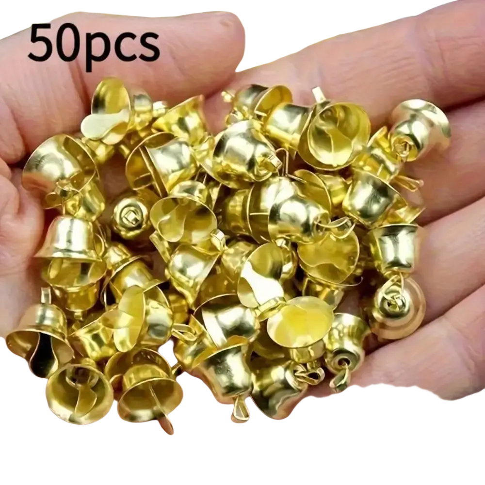 A hand holds fifty shiny gold-colored metal mini bell pendants for Christmas decorations and DIY handicrafts