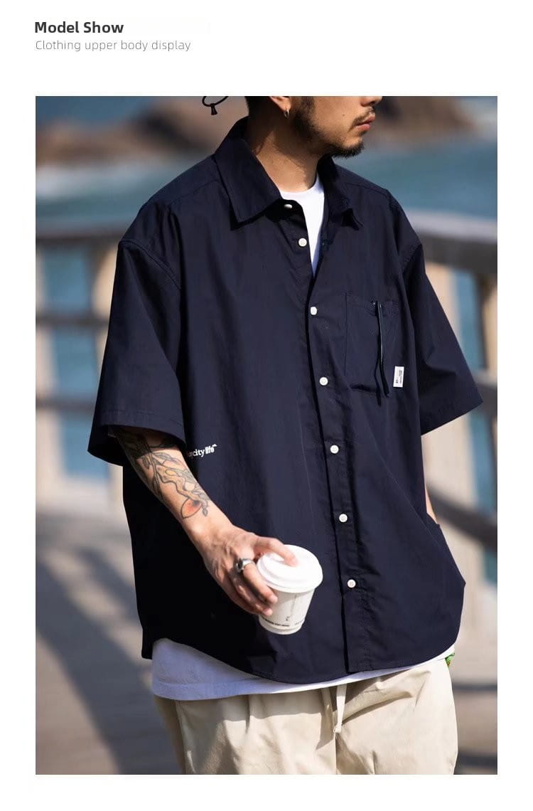 Mens casual short sleeve button up shirt in dark navy with a chest pocket and subtle branding on the sleeve.