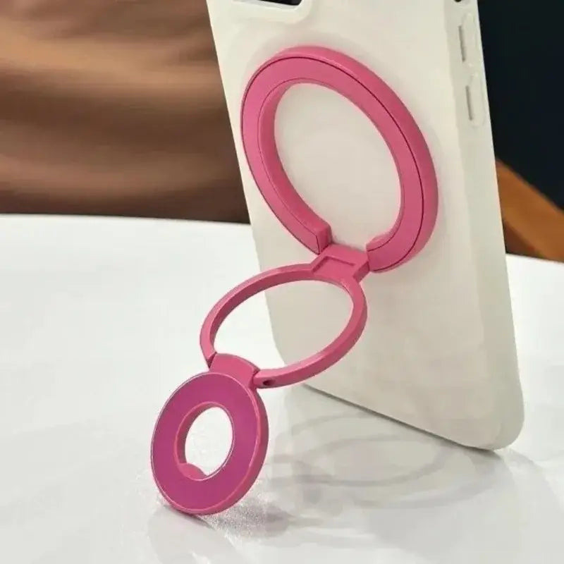 Anillo portateléfonos magnético de doble cara color rosa, con tres anillos circulares entrelazados en vista frontal para compatibilidad con Magsafe