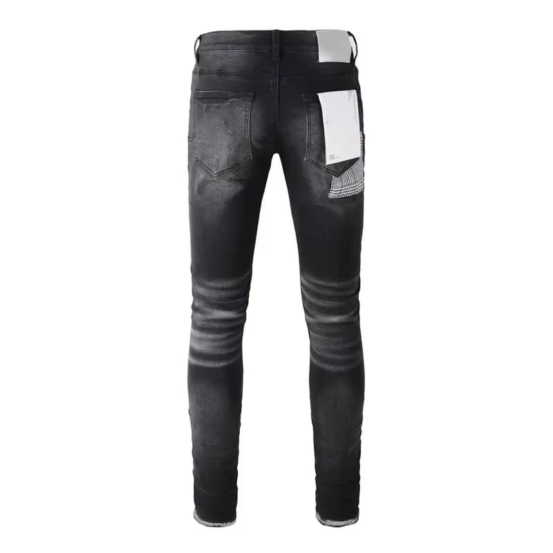 the back side of black distressed patchwork skinny jeans featuring slim-fit design, a faded wash, and a distinctive white patch on the right back pocket.