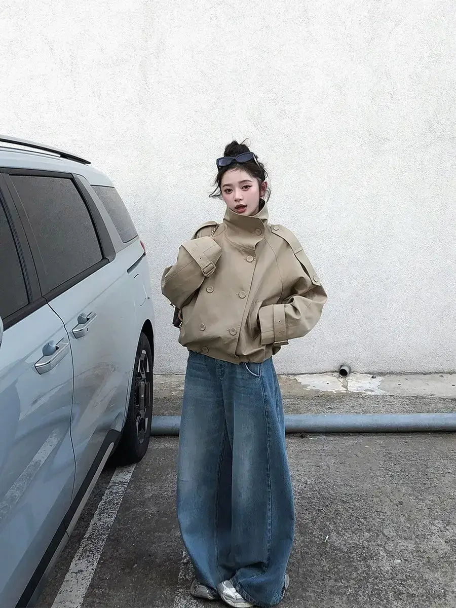 Beige Korean style trench coat featuring double-breasted buttons and wide structured shoulders.
