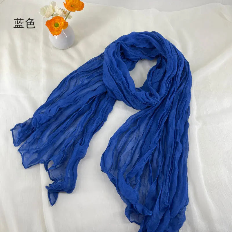 Écharpe en mousseline de chiffon bleu royal fluide, à la texture légère et douce et aux ondulations délicates, conçue comme une écharpe en coton et lin plissé.