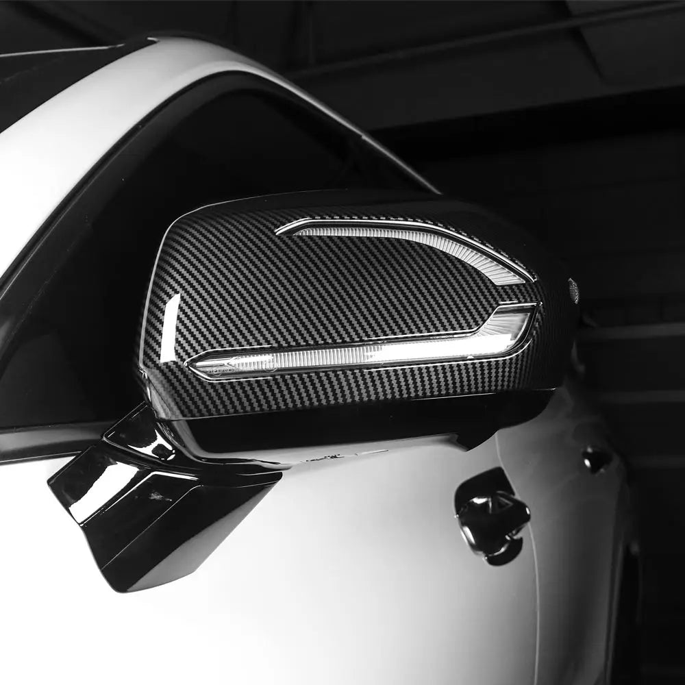 carbon fiber textured side mirror cover with integrated led light strip for hyundai palisade 2020-2025 shown from the back side