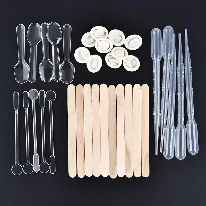 Set of clear plastic epoxy resin mixing tools including spoons pipettes and wooden sticks for DIY jewelry making.