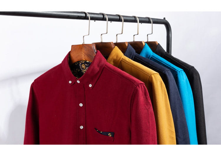 Ein maronfarbenes Herren-Cord-Casual-Langarmhemd für den Winter mit weißen Knöpfen und dekorativ gemustertem Besatz am Kragen, dargestellt in zwei Größen kleiner.