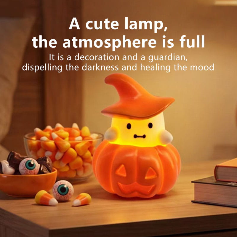 A glowing orange pumpkin-shaped halloween night light ornament with a witch’s hat and friendly face designed as a ghost-themed decoration.