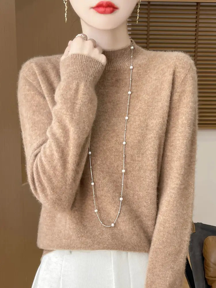 Beige merino wool pullover sweater for women featuring a soft-textured knit with a high neckline and long sleeves.